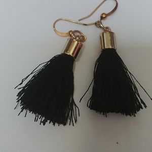 Black tassle earrings with gold ends.